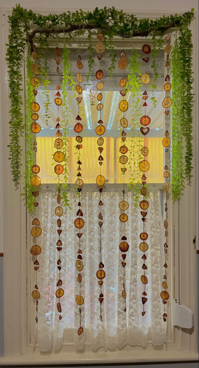 the window is decorated with plants and beads