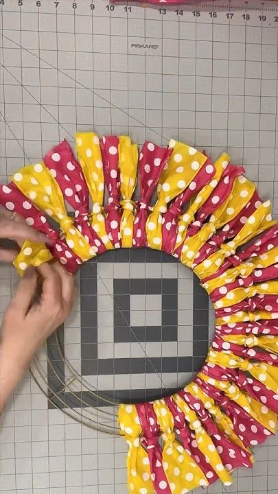 someone is making a wreath out of fabric