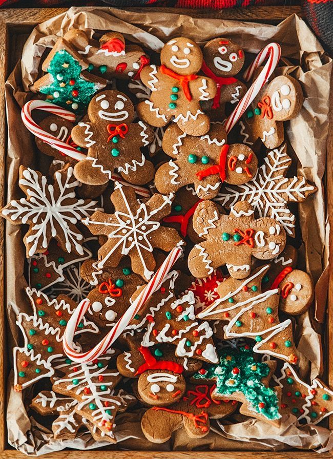 a wooden box filled with lots of different types of christmas cookies and candy canes