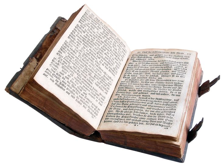 an open book with writing on it sitting in front of a white background that appears to be old