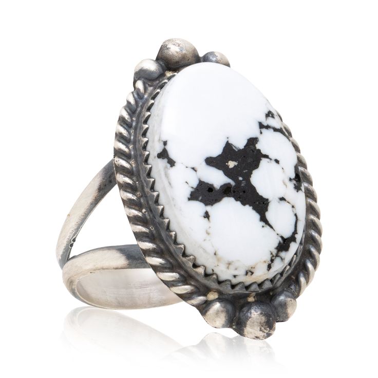 Native American Navajo Indian white buffalo turquoise and sterling silver ring. Quality, untreated natural stone set in sterling silver with twisted rope border. Stone is a bright stark white with deep black matrix blooming across center. Marked sterling with maker's initial on back. Lovely piece that would complement a modern Southwestern style. Size: Face 1 1/4" ring size 8 Inventory: AH0437 Family Owned & Operated Cisco's Gallery deals in the rare, exceptional, and one-of-a-kind pieces that define the history of America and the Old West. Our pieces range from American Indian to Cowboy Western and include original items of everyday life, commerce, art, and warfare that tamed America's frontier. Our 14,000 square foot gallery opened in 1996 in beautiful Coeur d'Alene, Idaho. Personal Serv Southwestern Style White Ring Jewelry, Southwestern Style White Round Rings, Southwestern Style Oval White Rings, Modern Southwestern, Navajo White, Rope Border, White Buffalo Turquoise, Zuni Jewelry, The Old West