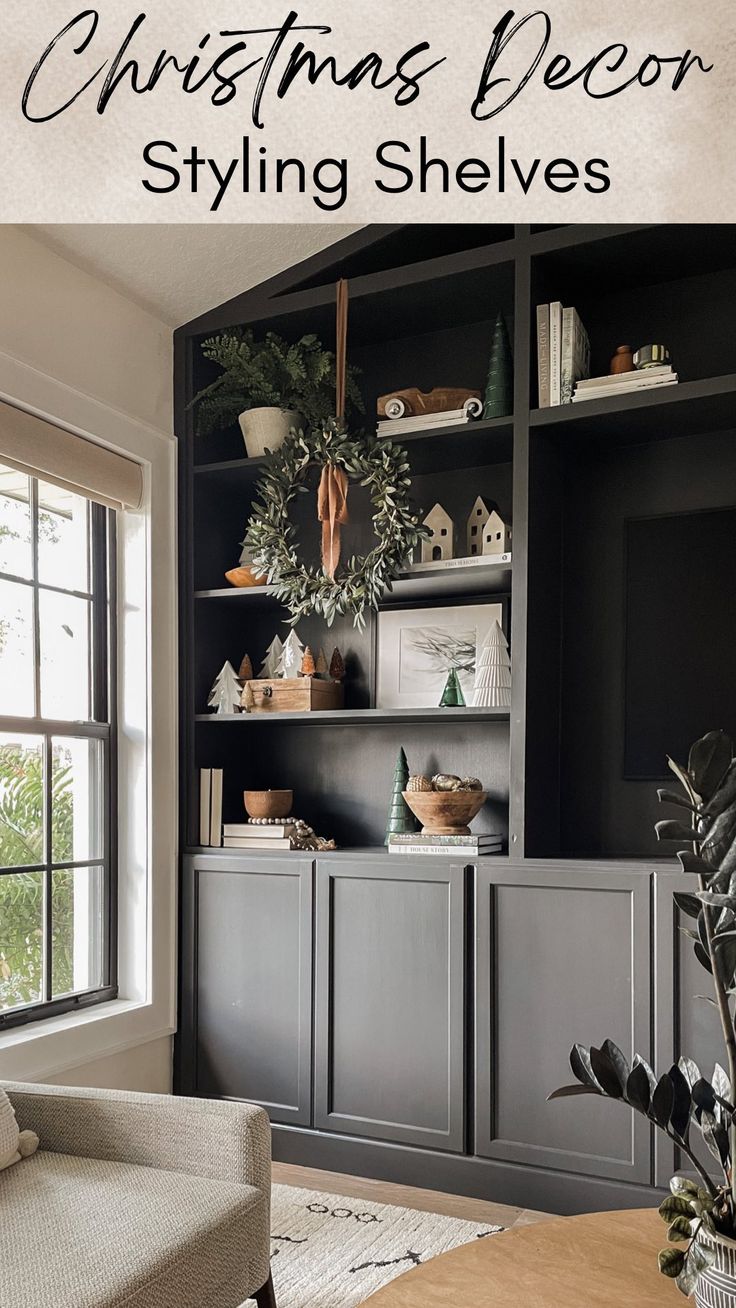 a living room filled with furniture next to a christmas wreath on top of a book shelf