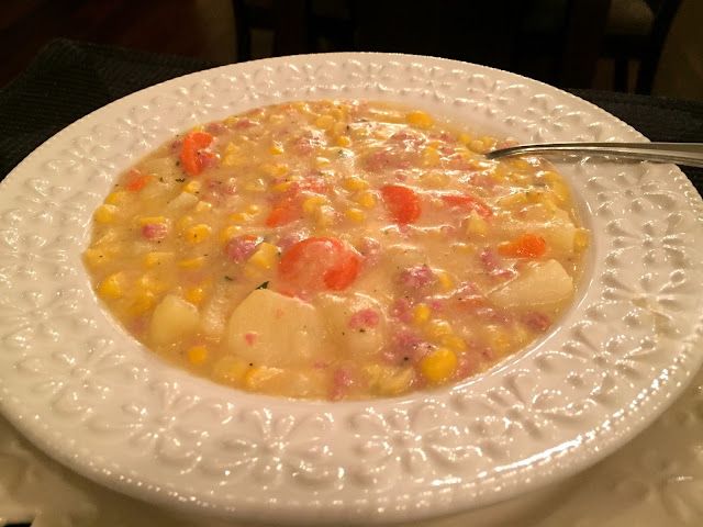 a white plate topped with corn and potatoes