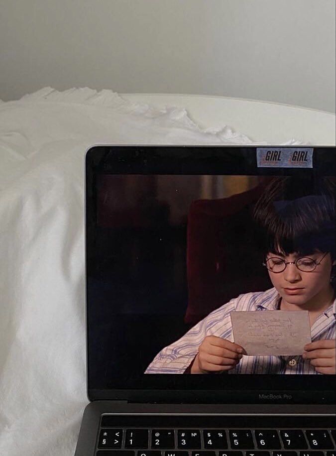 an open laptop computer sitting on top of a bed