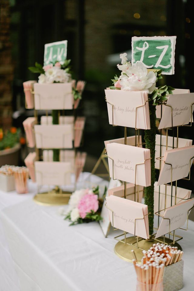 there are many cupcakes on the table with name tags attached to each one