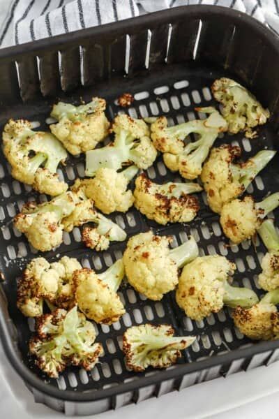 broccoli florets are being cooked in a grill grate on a towel