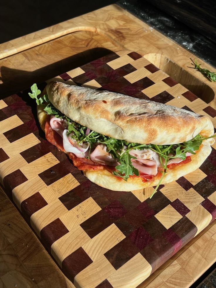 a sandwich is sitting on a cutting board