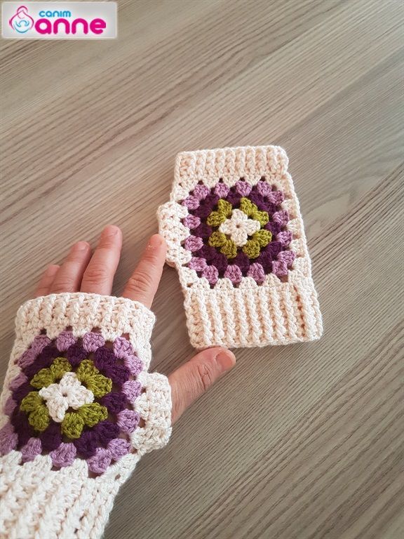 two crocheted hand warmers are shown on a table