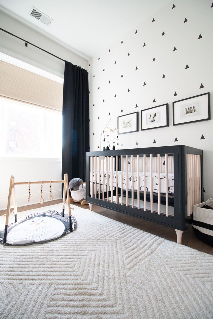 a baby's room with black and white decor