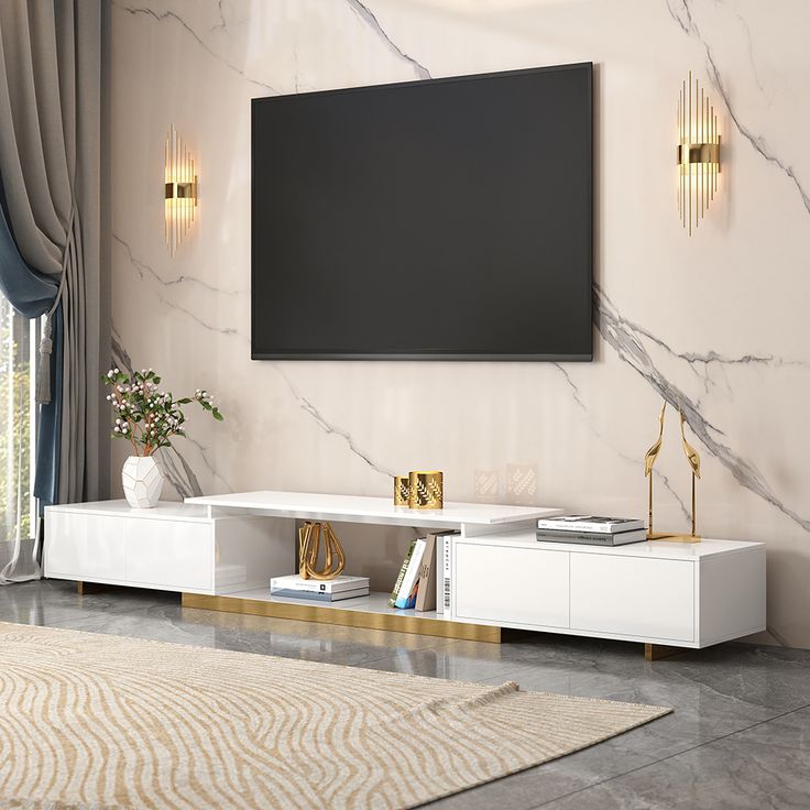 a modern living room with marble walls and white furniture, including a large flat screen tv mounted on the wall