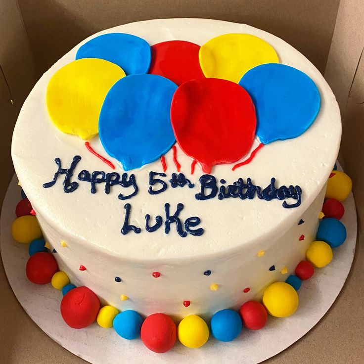 a birthday cake decorated with balloons and the words happy 5th birthday luke written on it