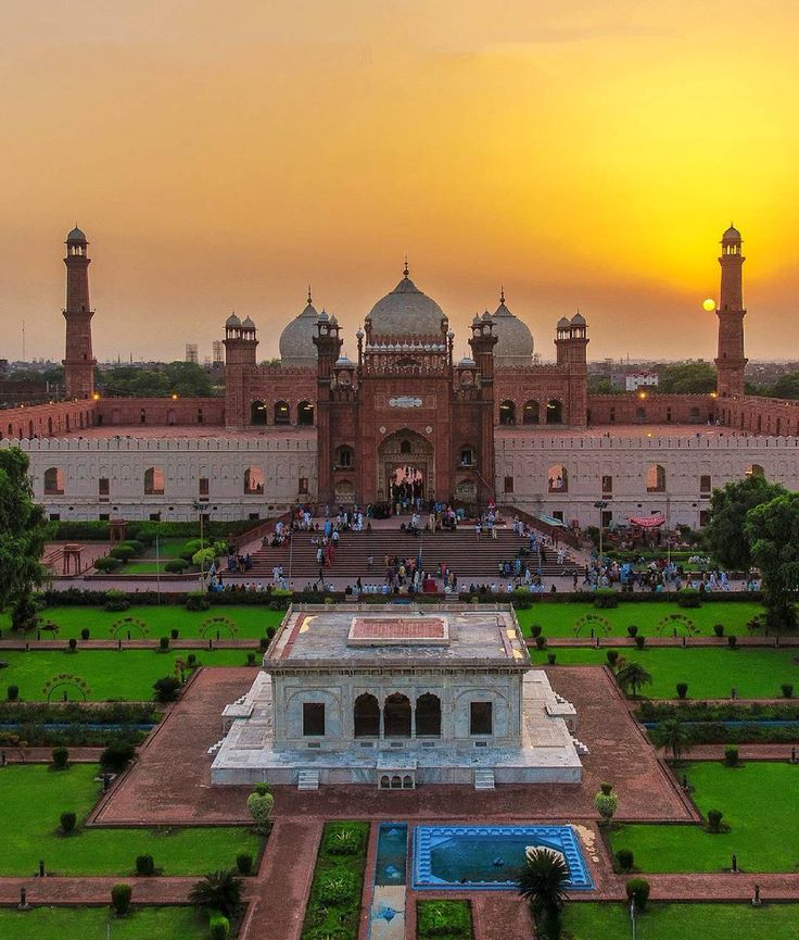 an aerial view of the taj muscah at sunset, with people walking around