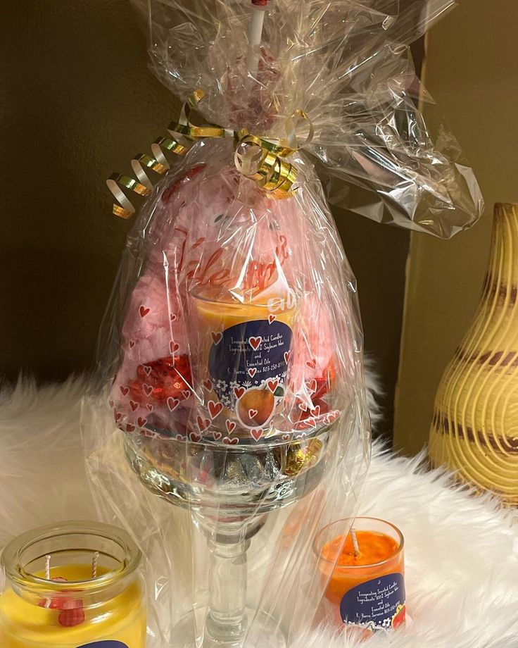 a wine glass filled with candy and candies next to a jar of jellys