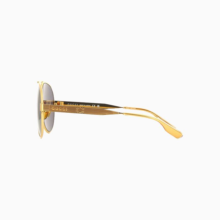 For the Cruise 2024, these sunglasses are defined by an aviator shape. Crafted from gold-toned metal, the silhouette is embellished by a top bar, engraving, and Gucci lettering along the temples. A solid grey lens completes the design. More Details Shiny gold-toned metal frame with top bar Shiny gold-toned metal temples with engraving and Gucci lettering, acetate tips Solid grey lens 100% UVA/UVB protection Rubber nose pads Frame height: 5.8 cm, frame width: 14.9cm Temple length: 14.5cm; Lens he Grey Sunglasses, Gold Sunglasses, Grey Lenses, Grey Fashion, Gold Tone Metal, Metal Frame, Gold Tones, Man Shop, Gucci