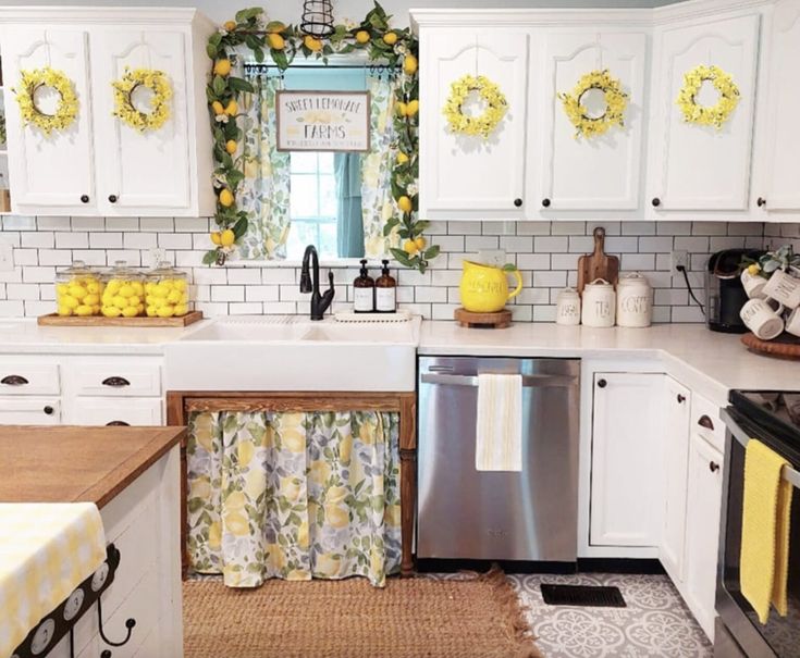 a kitchen with white cabinets and yellow decorations on the window sill above the sink