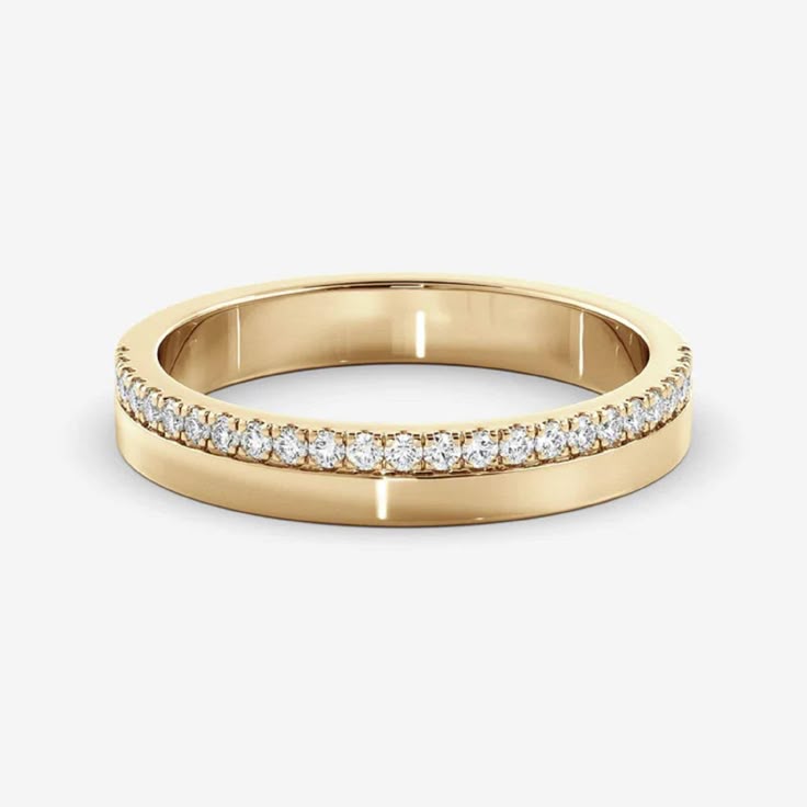 a yellow gold wedding band with rows of diamonds