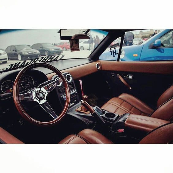 the interior of a car with brown leather seats