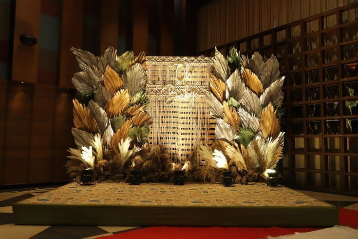 an elaborately decorated stage with feathers on it