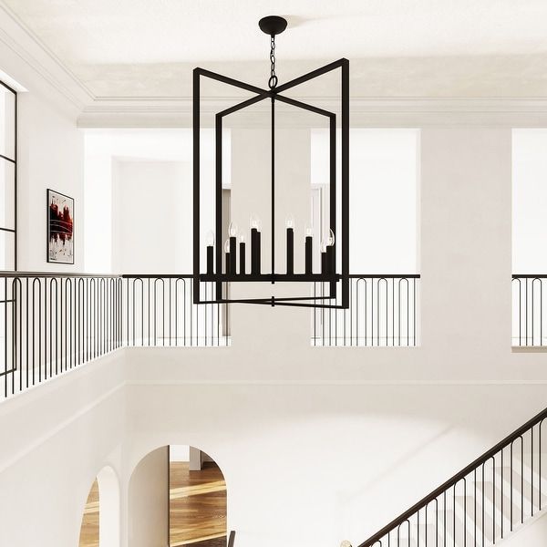 a chandelier hanging from the ceiling in a room with white walls and wood flooring