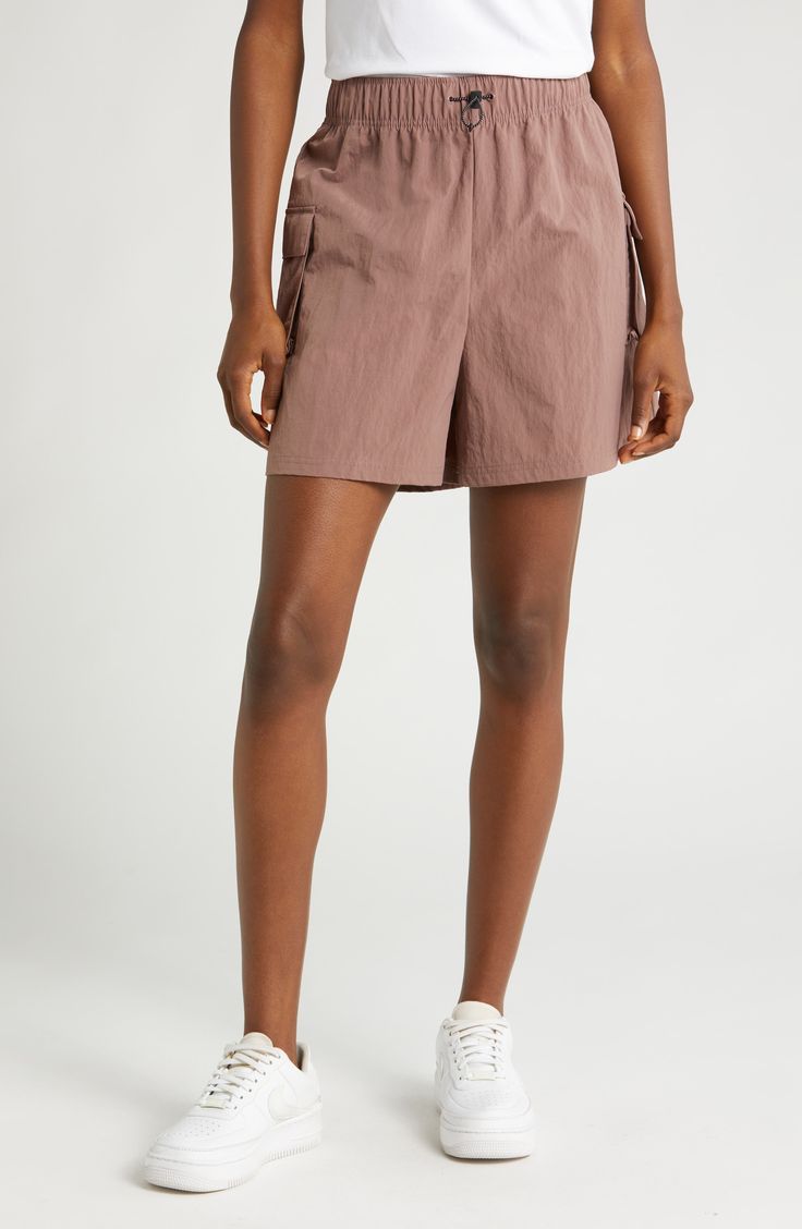 These high-waisted shorts are made from a soft, smooth woven fabric with a roomy fit, making them perfect for workouts and casual wear. Cargo pockets allow for secure storage of your small essentials. 4 1/2" inseam; 28" leg opening; 13" front rise; 17" back rise (size Medium) Drawcord-toggle waist 100% nylon Machine wash, tumble dry Imported