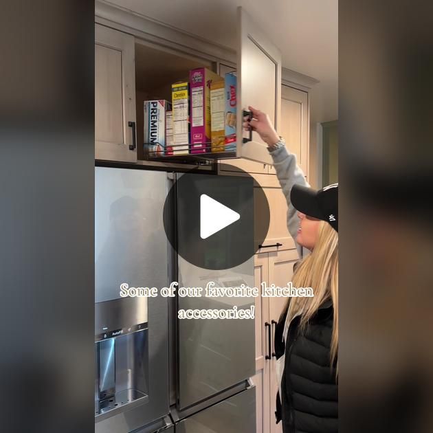 a woman is opening the refrigerator door to check out what's inside