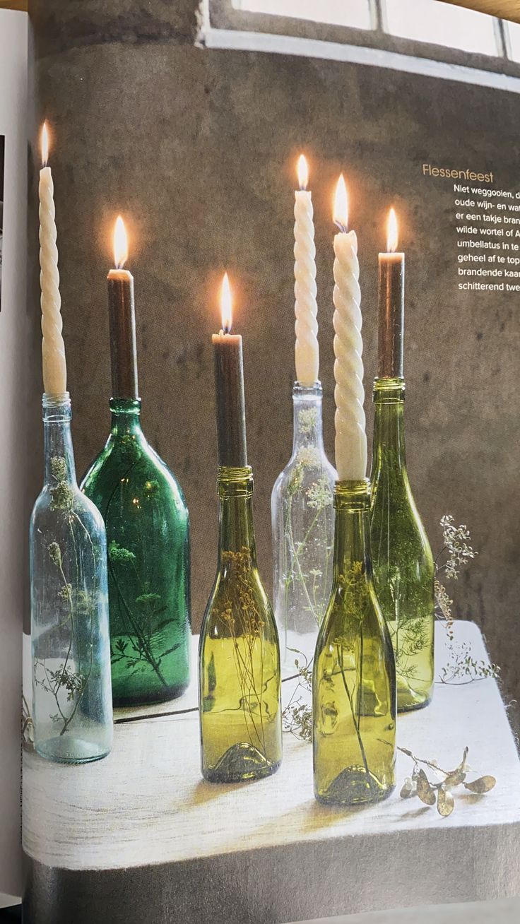 an open magazine with candles in glass bottles