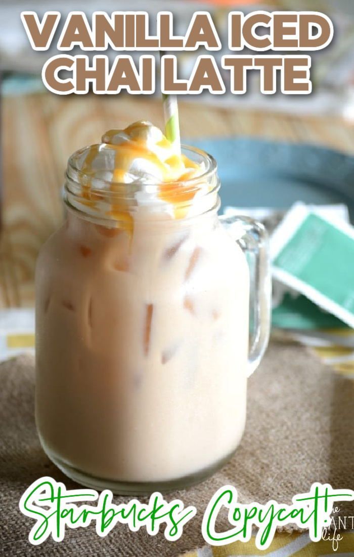 an iced drink with whipped cream and toppings in a mason jar on a table