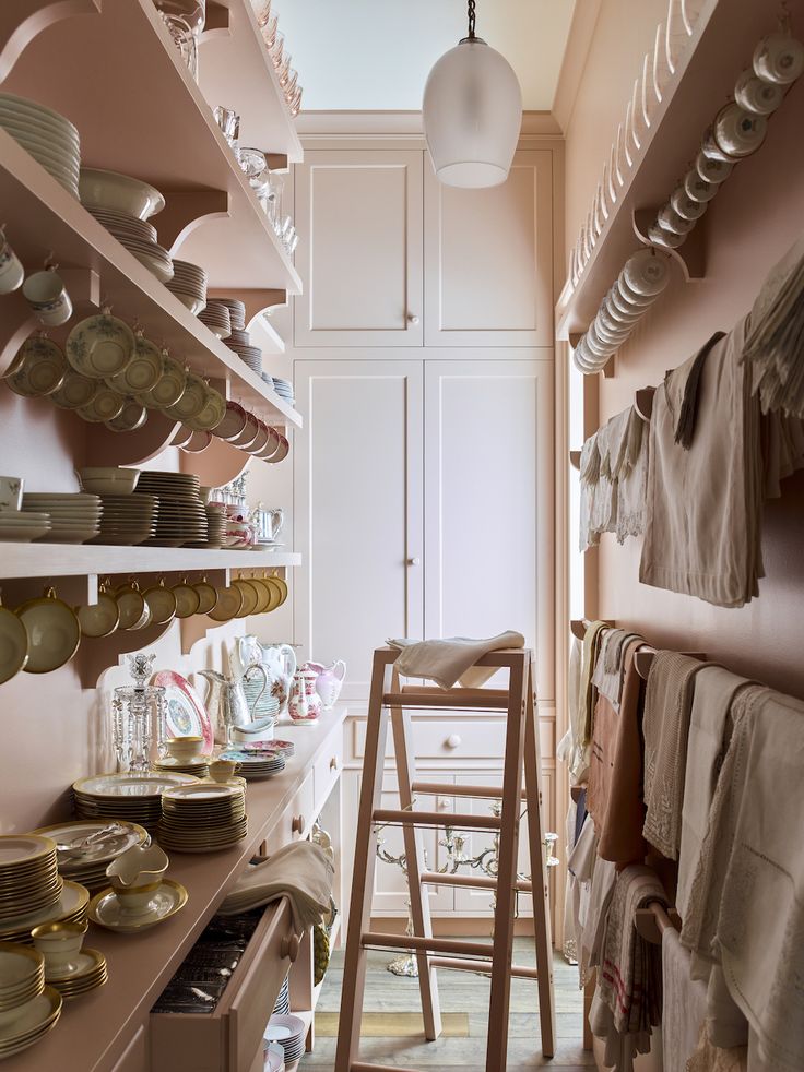 the shelves in this kitchen are filled with dishes and plates, but no one is using them