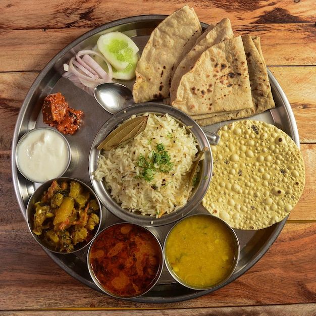 a metal plate topped with different types of food