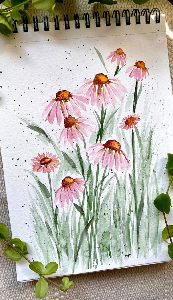 watercolor painting of pink flowers on white paper next to green leaves and plants in the background