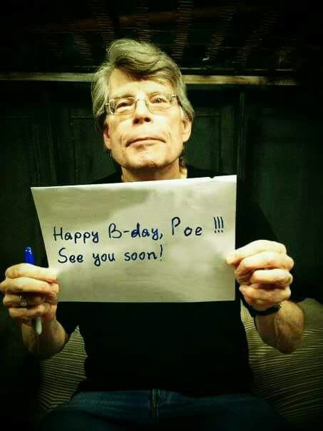 an older man holding up a sign that says happy b - day poe see you soon