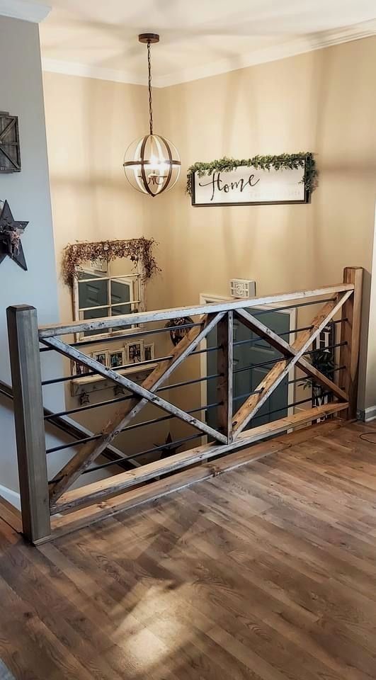 a room with wooden floors and a metal railing