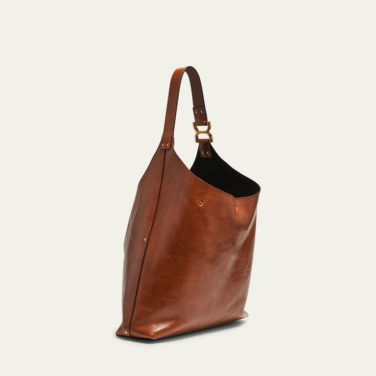 Chloe "Marcie" hobo bag in shiny calfskin  Shoulder strap  Open top with center leather straps  Interior, one zip pocket  Lining: Leather Approx. 11.4"H x 14.2"W x 3.9"D Made in Italy Brown Calf Leather Shoulder Bag With Brass Hardware, Luxury Cognac Bag With Brass Hardware, Everyday Shoulder Bag With Double Handle And Palladium Hardware, Classic Everyday Luxury Shoulder Bag With Leather Handles, Leather Top Handle Shoulder Bag With Brass Hardware, Chic Calf Leather Bag With Brass Hardware, Designer Hobo Bag With Leather Handles For Everyday, Rectangular Shoulder Bag With Leather Handles For Everyday Luxury, Luxury Bags With Brass Hardware For Everyday Use