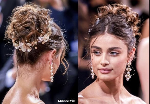 Taylor Hill Met Gala 2022 Hair, Fancy Hair And Makeup, Prom Updos Front View, Messy Bun Red Carpet, Updo Hairstyles With Accessories, Updo For Ball, Updo With Jewels, Low Curly Bun Wedding Hair Tutorial, Floral Updo Hairstyles