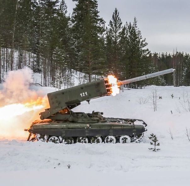 an army tank is on fire in the snow