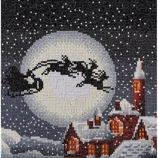 a cross stitch picture of a snowman and his sleigh in the night sky