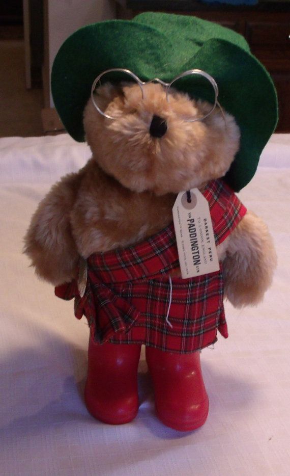 a teddy bear wearing glasses and a green hat