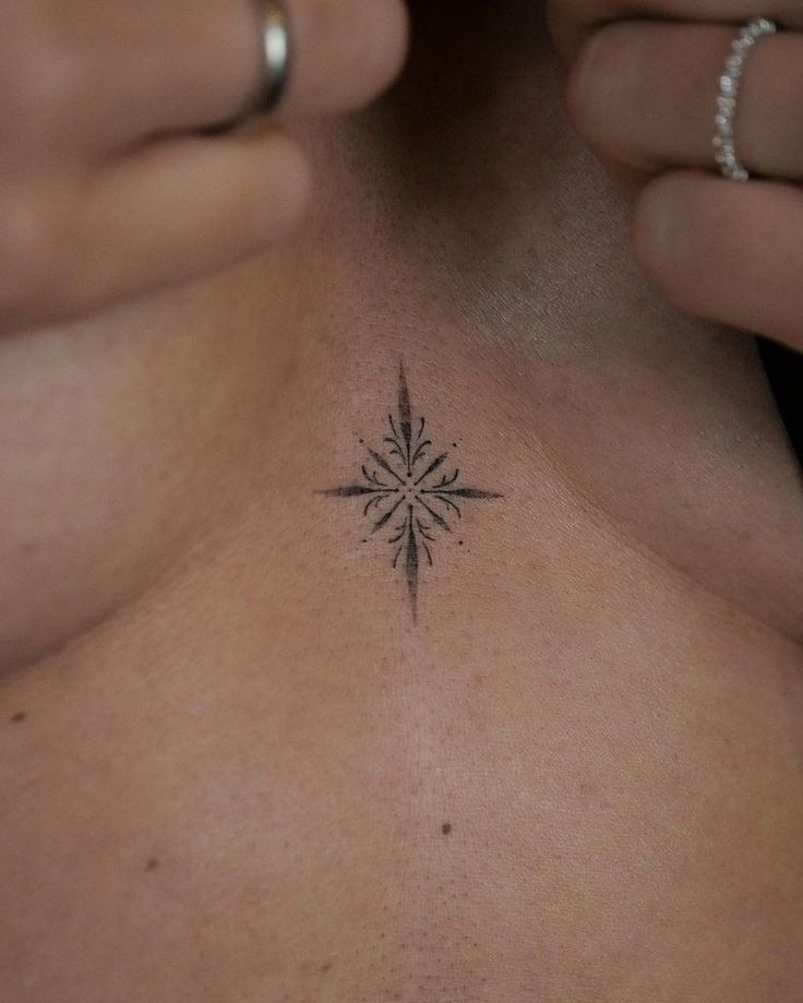 a woman's chest with a small tattoo design on her left side ribcage