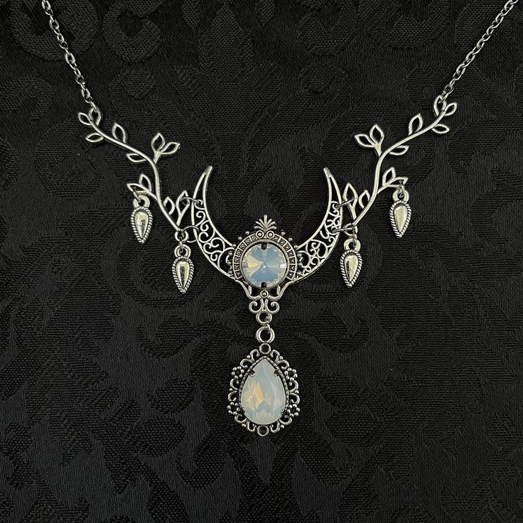 "This enchanting moon elf necklace features richly detailed antiqued silver tone filigree crescent, intricate leafy branches and elegant scroll drop accents. Its captivating design is adorned with dazzling white opal glass crystals. Decorated portion is 4 1/2\" wide and 2 1/2\" tall in the very center.  Necklace length is adjustable with soldered stainless steel cable chain, lobster clasp and extender. If you would like a different length, please send us a message. Matching headpiece, pendant an Elf Necklace, Moon Goddess Jewelry, Raw Carnelian, Dancer Necklace, Moon Elf, Ballerina Necklace, Moon Goddess Necklace, Gothic Engagement Ring, Elven Jewelry