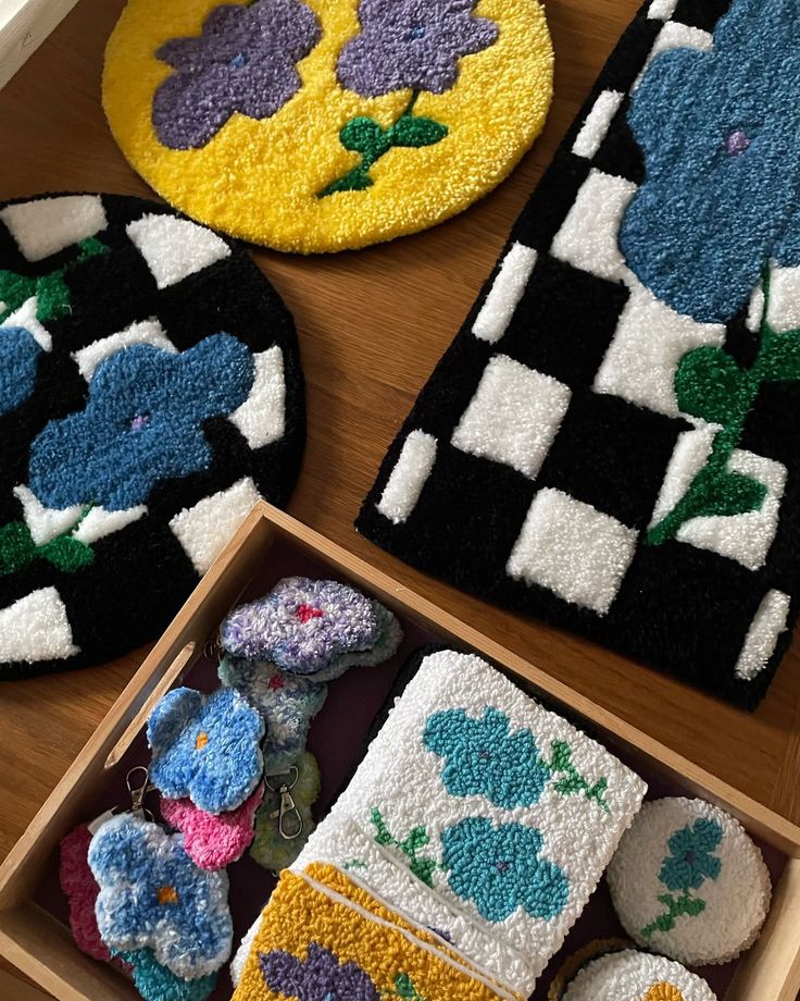 three different colored rugs in a box on a table with buttons and magnets