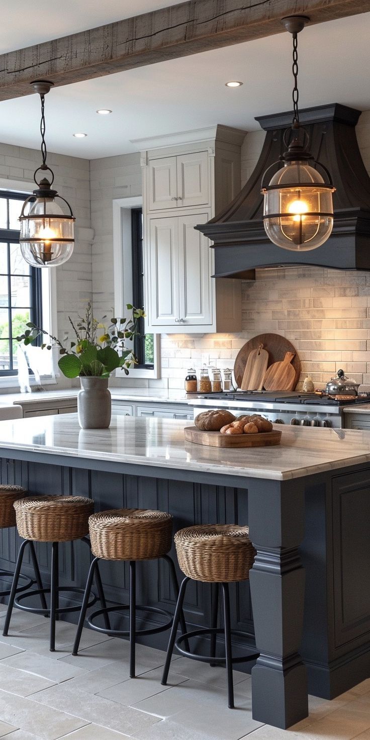 a kitchen island with stools and lights hanging from it's ceiling over the counter