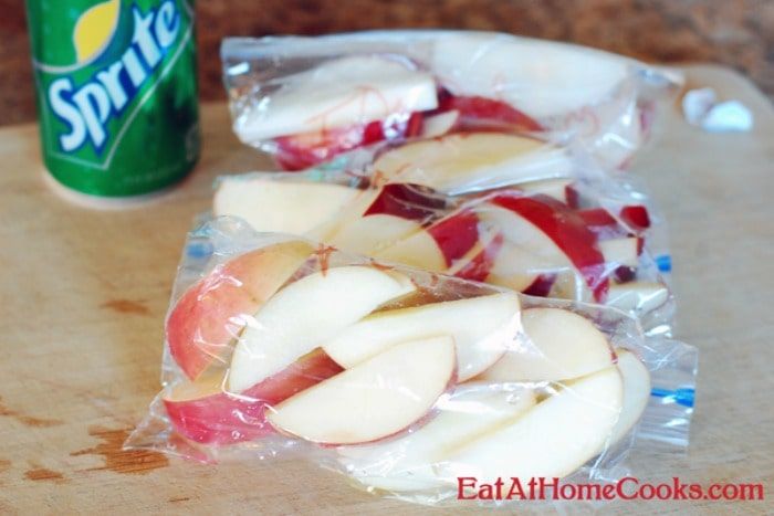 sliced apples in plastic bags next to a can of spriter's apple cider