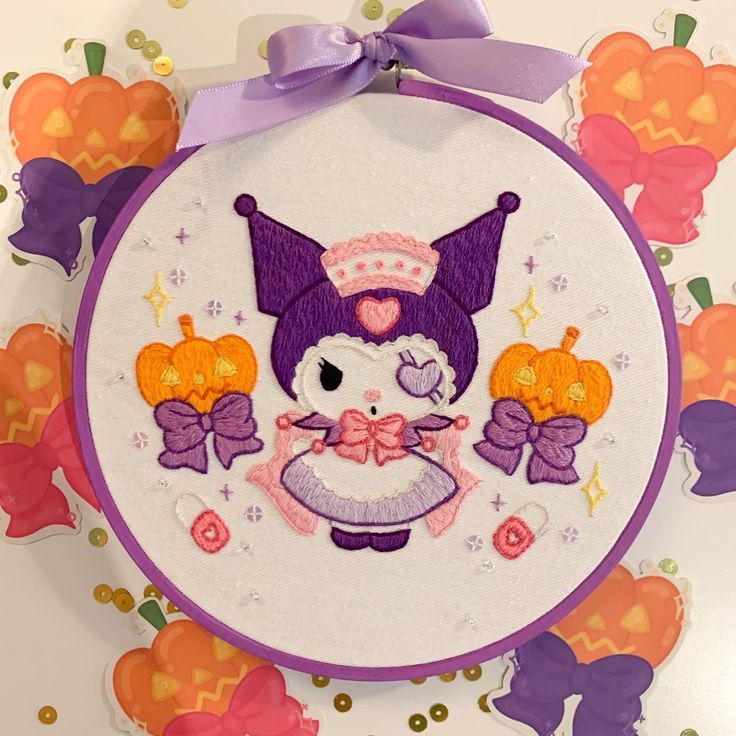 an embroidery kit with a cat and pumpkins in the hoop on top of it