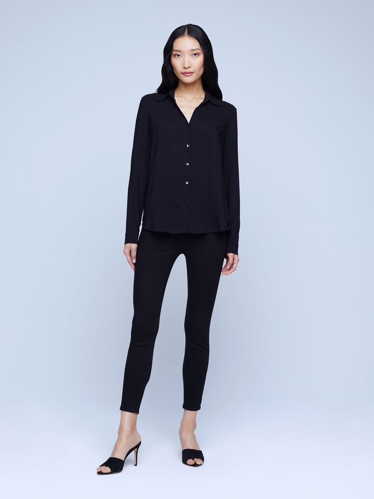 A modern classic. The Nina blouse is structured in all the right places with a relaxed, flattering fit. Refined button-down construction with a chic open collar and draped long sleeve in black silk. Sleek Button-up Blouse For Business Casual, Sleek Office Wear Button-up Blouse, Chic Blouse With Lapel Collar For Business, Chic Business Blouse With Lapel Collar, Sleek Long Sleeve Blouse For Office Wear, Sleek Fall Office Wear Blouse, Sleek Blouse For Office Wear In Fall, Sleek Office Wear Blouse For Fall, Chic Blouse With Lapel Collar For Daywear