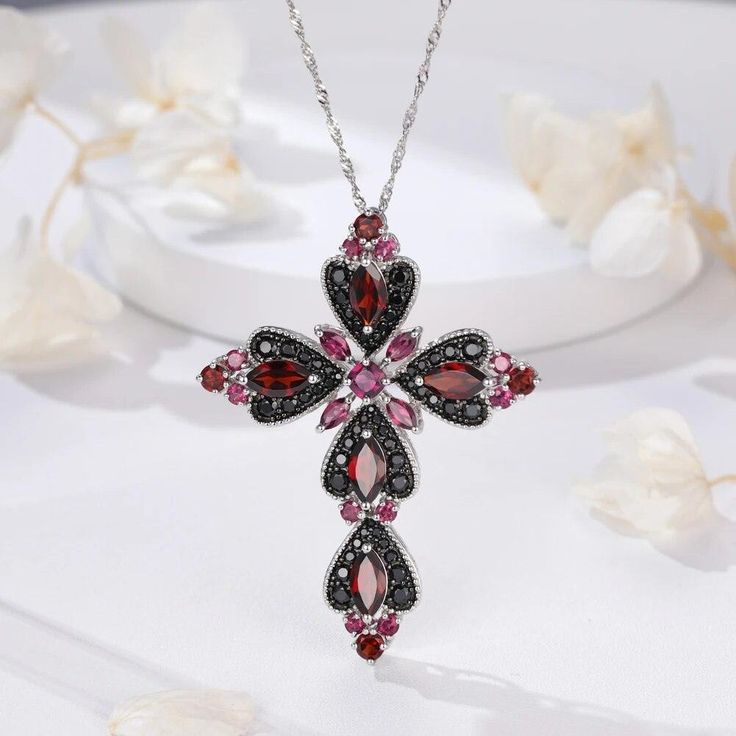 Elegant 925 Sterling Silver Cross Necklace with 8.8ct Natural Rhodolite and Black Spinel Gemstones Crafted from high-quality 925 sterling silver, this exquisite pendant necklace showcases an elegant cross design that is perfect for any occasion. Stunning Gemstone Details This statement piece features: Gemstone Weight: 8.8ct total Gemstones: Natural rhodolite and black spinel Stone Size: Marquise 10*5mm Stone Cutting: Good cut Luxury and Sophistication The combination of colorful natural rhodolit Silver Cross Necklace, Sterling Silver Cross Necklace, Spinel Gemstone, Sterling Silver Cross Pendant, Silver Cross Pendant, Cross Ring, Black Spinel, Cross Jewelry, Sterling Silver Cross