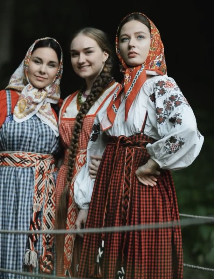 three women in traditional dress standing next to each other