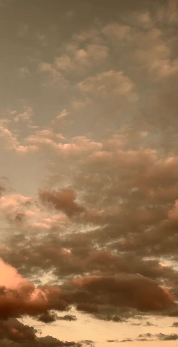 an airplane is flying through the cloudy sky