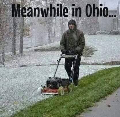 a man is mowing the grass with his lawnmower on a snowy day