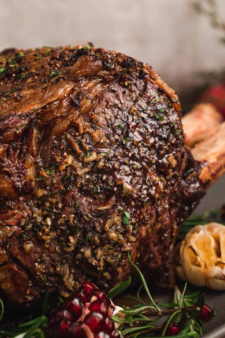 a large piece of meat sitting on top of a plate next to other food items