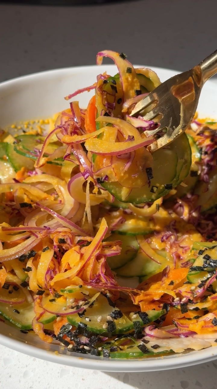 a white bowl filled with assorted veggies on top of a table